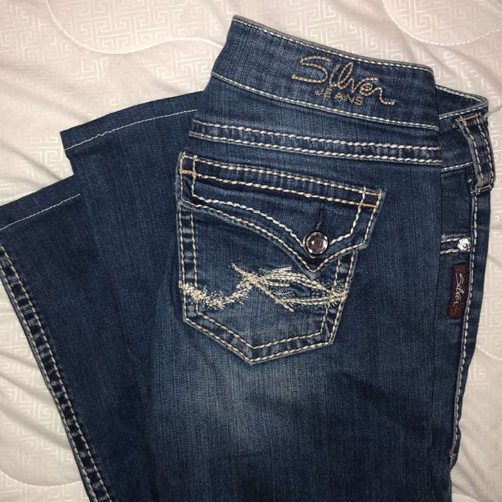 Silver blue jeans with detailed stitching and gems